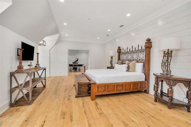 bedroom with wood walls, light hardwood / wood-style flooring, and ornamental molding