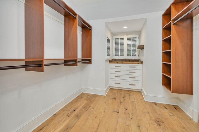 walk in closet featuring light hardwood / wood-style flooring