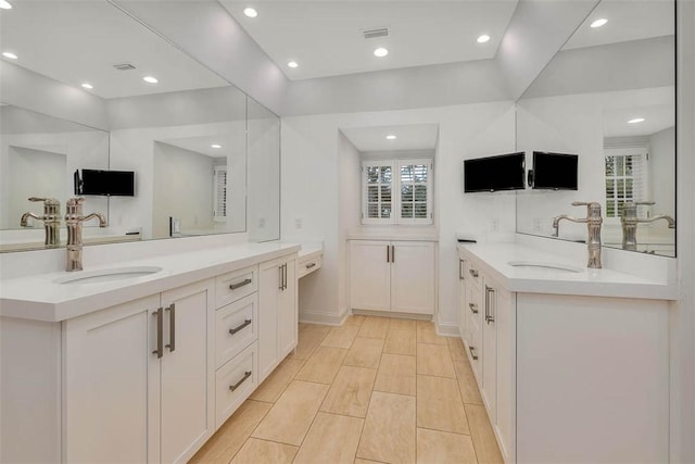 bathroom featuring plenty of natural light and vanity