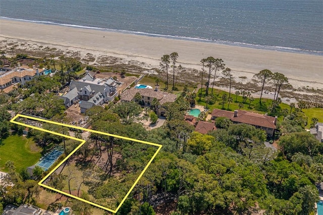 bird's eye view featuring a water view and a beach view