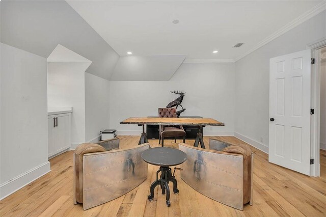 home office with ornamental molding, lofted ceiling, and light wood-type flooring