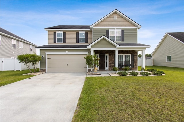 259 Daniel Trent Way, Kingsland, GA 31548 - view of front of house with a garage, driveway, stone siding, and a porch