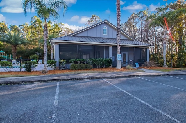 259 Daniel Trent Way, Kingsland, GA 31548 - view of front of property with a sunroom, uncovered parking, a standing seam roof, and a metal roof