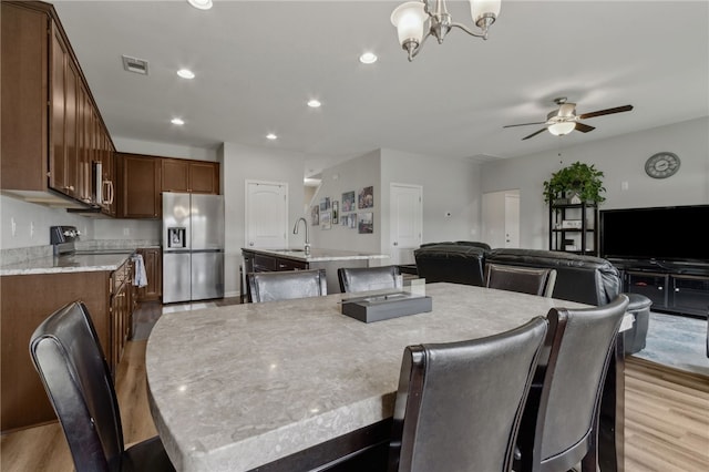 259 Daniel Trent Way, Kingsland, GA 31548 - dining space featuring light wood-style flooring, a ceiling fan, a chandelier, and recessed lighting