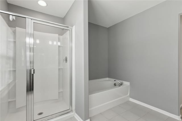 259 Daniel Trent Way, Kingsland, GA 31548 - bathroom featuring a shower stall, a garden tub, and tile patterned flooring