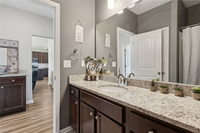 259 Daniel Trent Way, Kingsland, GA 31548 - full bathroom featuring vanity, wood finished floors, and ensuite bathroom