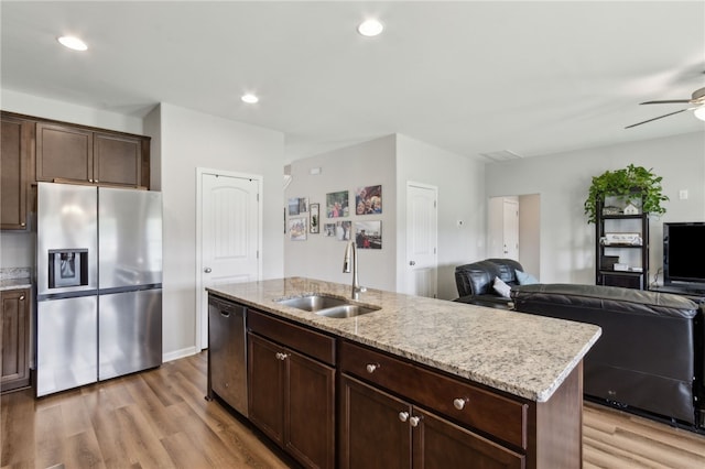259 Daniel Trent Way, Kingsland, GA 31548 - kitchen featuring stainless steel appliances, light wood-style floors, a ceiling fan, open floor plan, and light stone counters