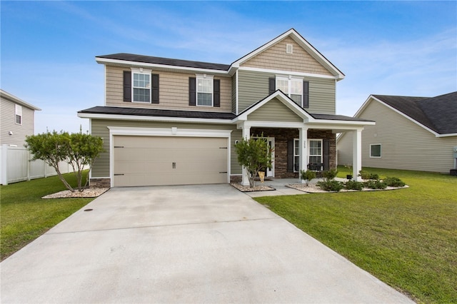 259 Daniel Trent Way, Kingsland, GA 31548 - view of front of house with a garage, driveway, stone siding, and a porch