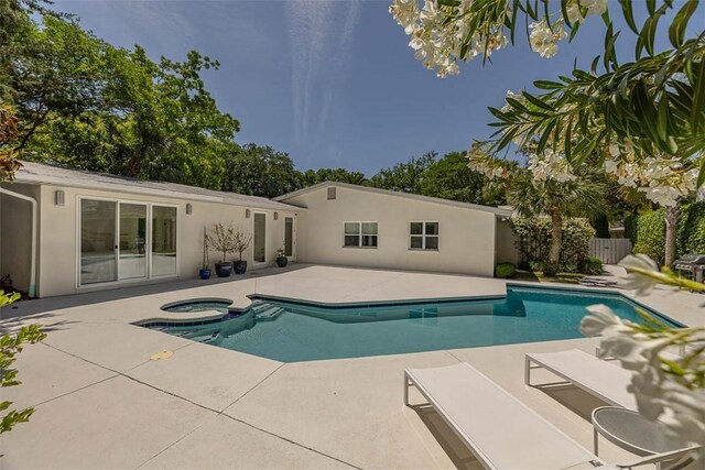 4218 Fifth St, Saint Simons Island, GA 31522 - view of pool with a patio area, a pool with connected hot tub, and fence
