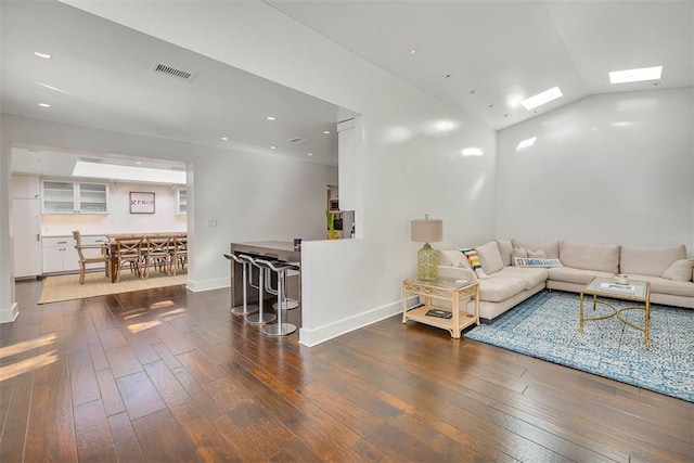 living area with recessed lighting, wood-type flooring, visible vents, and baseboards