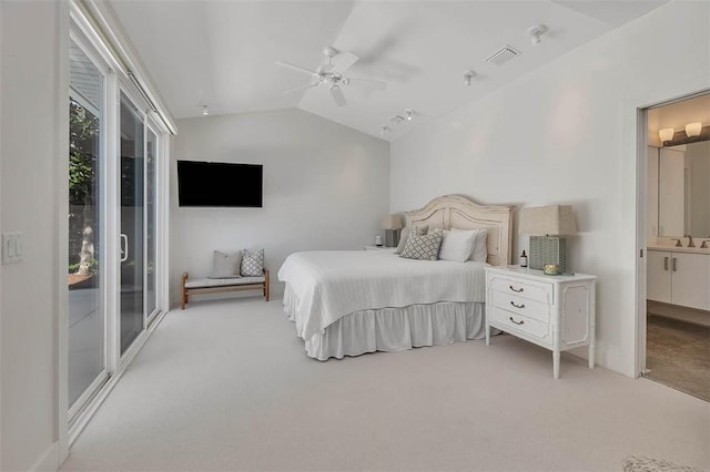 bedroom featuring lofted ceiling, light carpet, a sink, and visible vents