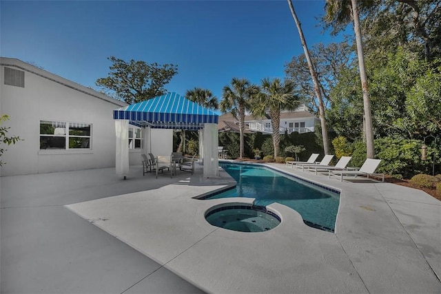 view of swimming pool with a pool with connected hot tub and a patio