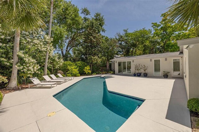 4218 Fifth St, Saint Simons Island, GA 31522 - swimming pool with a patio area and view of scattered trees