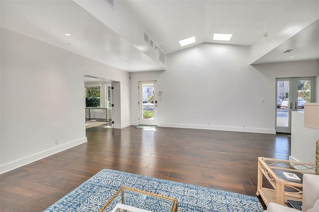 living room featuring a wealth of natural light, wood finished floors, and french doors