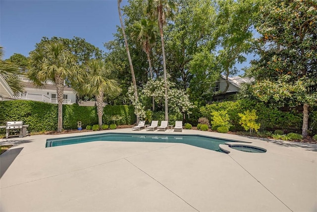 4218 Fifth St, Saint Simons Island, GA 31522 - view of swimming pool with a patio area, area for grilling, and a pool with connected hot tub