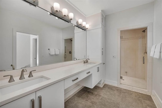 bathroom featuring double vanity, a stall shower, and a sink