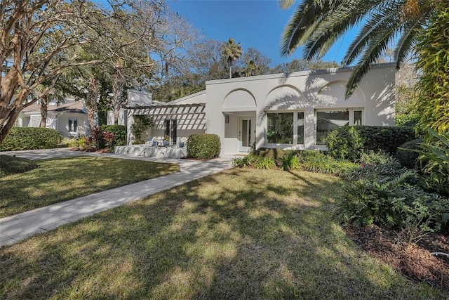 view of front facade featuring a front yard and stucco siding