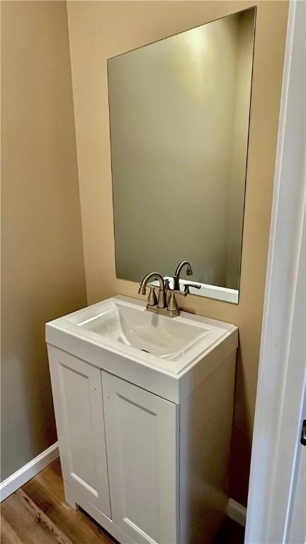 bathroom with vanity and wood-type flooring