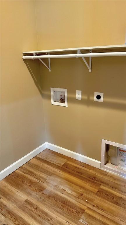 laundry room with electric dryer hookup, hookup for a washing machine, and hardwood / wood-style flooring