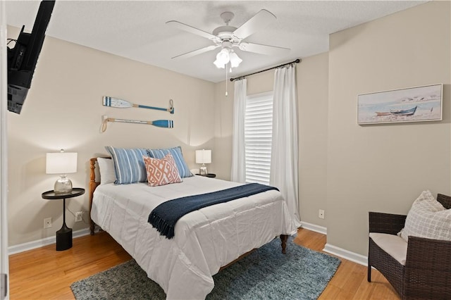 bedroom with ceiling fan and hardwood / wood-style floors