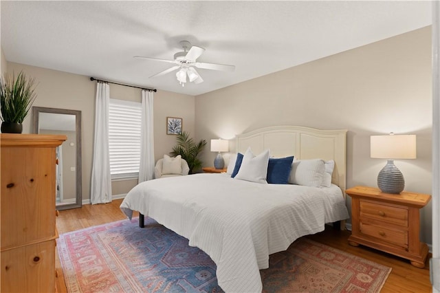 bedroom with hardwood / wood-style flooring and ceiling fan