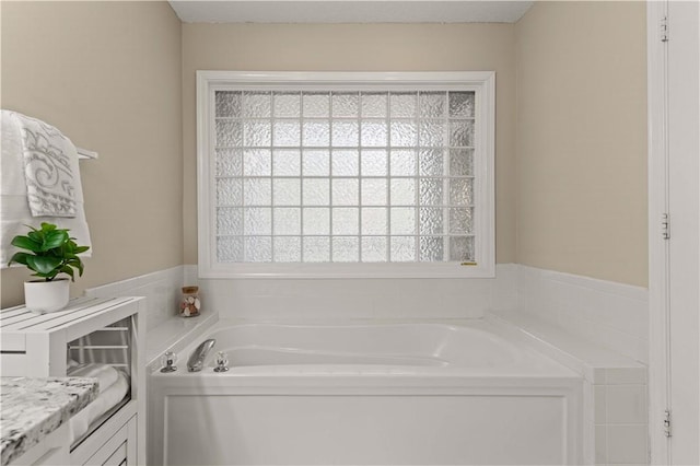 bathroom featuring vanity and a bath