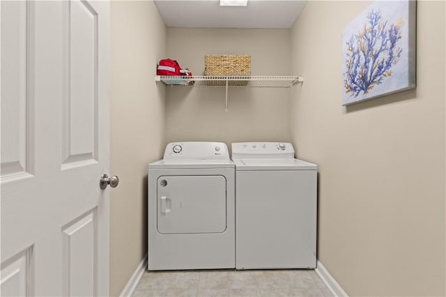 clothes washing area featuring independent washer and dryer