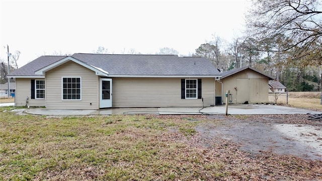 rear view of house featuring a yard and a patio