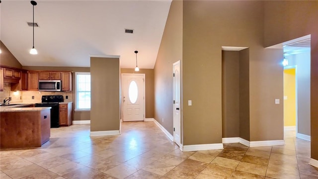 foyer featuring sink and high vaulted ceiling