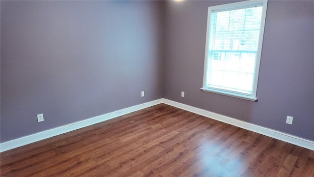 spare room with hardwood / wood-style flooring