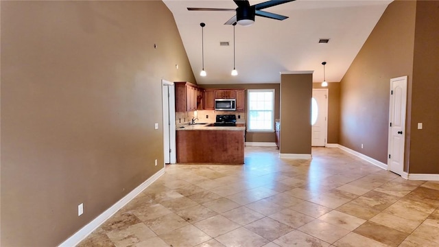 kitchen featuring ceiling fan, kitchen peninsula, high vaulted ceiling, and stove