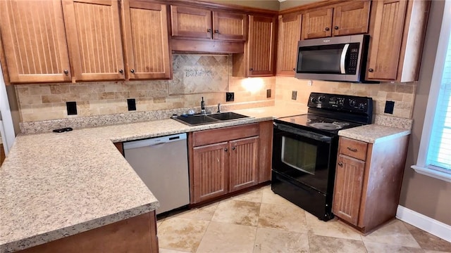 kitchen with stainless steel appliances, sink, and backsplash