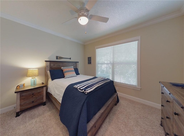 carpeted bedroom featuring ceiling fan, ornamental molding, and a textured ceiling