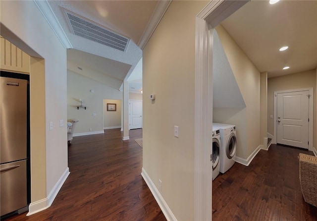 laundry area with dark wood-type flooring, crown molding, and washer and clothes dryer