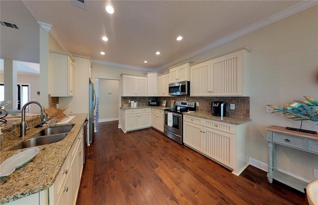 kitchen featuring tasteful backsplash, appliances with stainless steel finishes, sink, and light stone counters