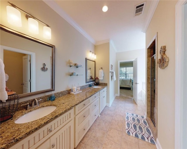 bathroom featuring ornamental molding, a shower with shower door, tile patterned floors, and vanity