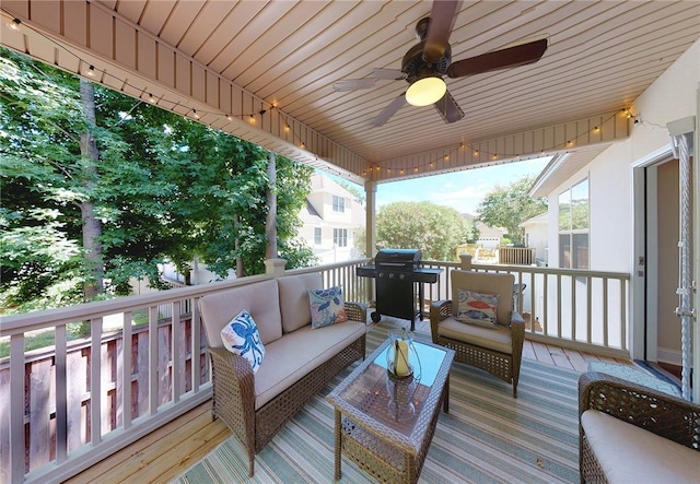 wooden terrace featuring grilling area, an outdoor hangout area, and ceiling fan