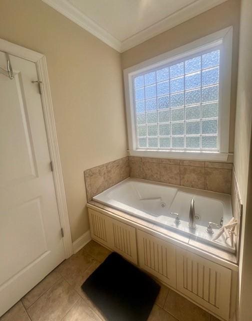 bathroom with a tub to relax in, ornamental molding, and tile patterned flooring