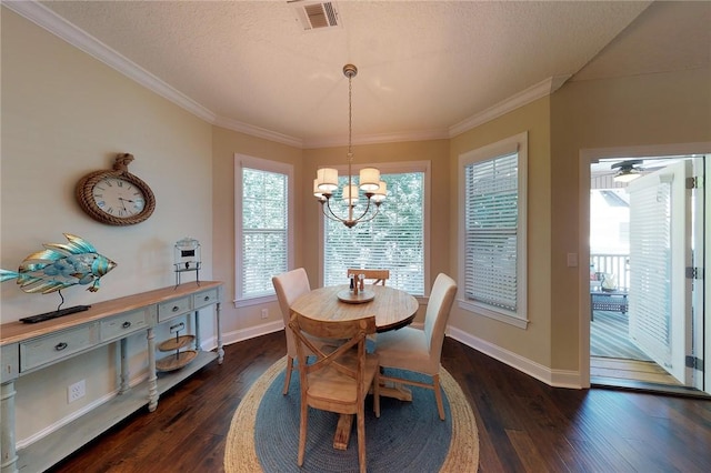 dining area featuring dark wood-type flooring, crown molding, an inviting chandelier, and a textured ceiling