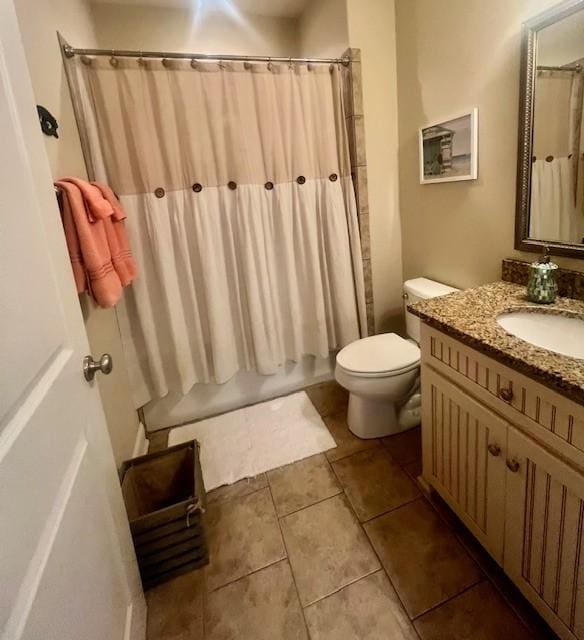 full bathroom with vanity, tile patterned floors, toilet, and shower / bath combo with shower curtain