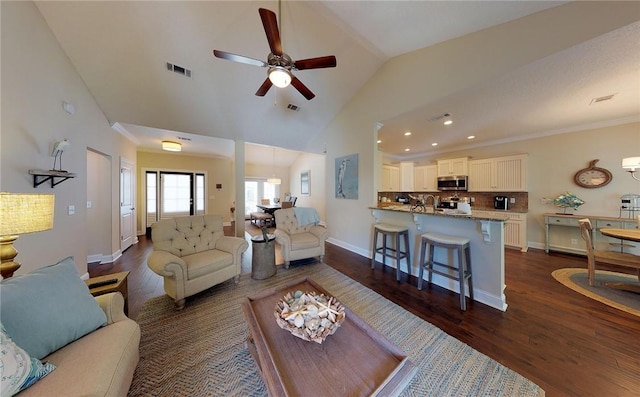 living room with ceiling fan, high vaulted ceiling, crown molding, and dark hardwood / wood-style flooring