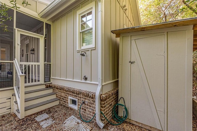 entrance to property featuring visible vents and board and batten siding