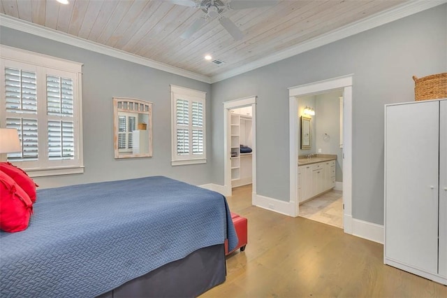 bedroom featuring crown molding, baseboards, wood ceiling, ensuite bathroom, and wood finished floors