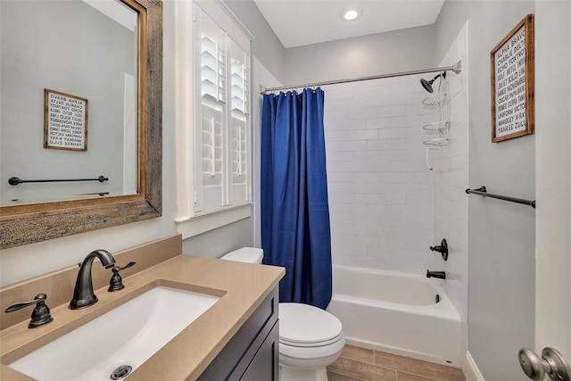 bathroom featuring vanity, toilet, and shower / tub combo with curtain