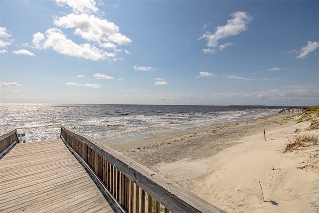 view of home's community featuring a beach view and a water view