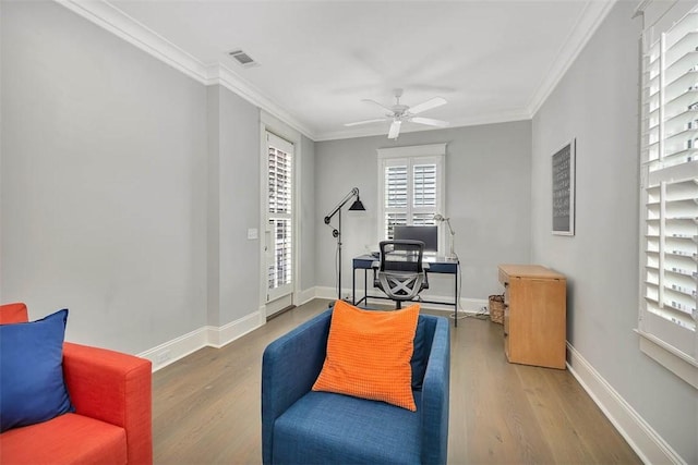 home office featuring visible vents, wood finished floors, and ornamental molding