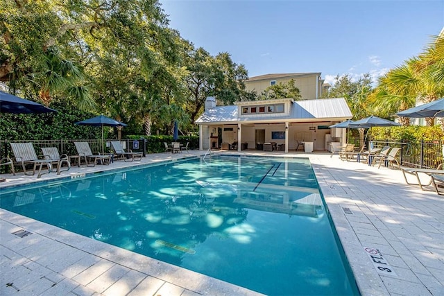 pool featuring a patio and fence