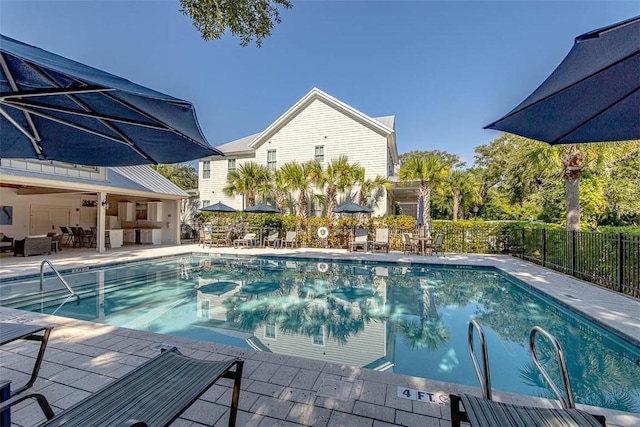 pool with fence and a patio area