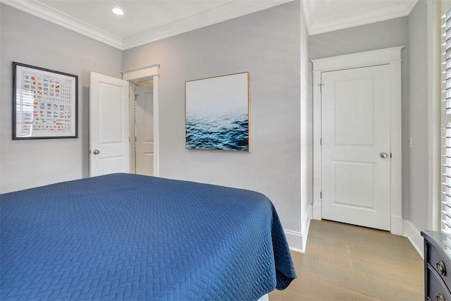 bedroom featuring recessed lighting, wood finished floors, baseboards, and ornamental molding