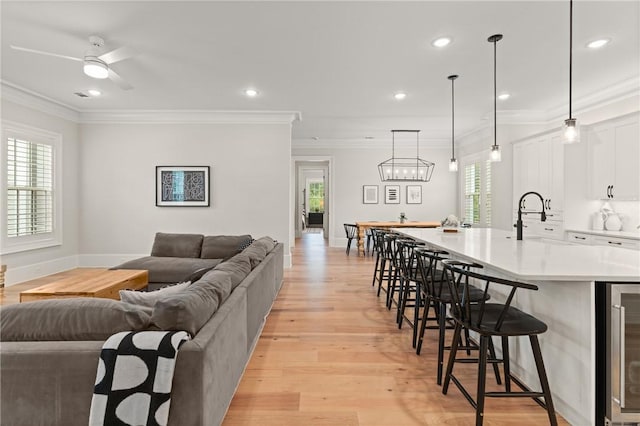 166 Robertson Cir, Saint Simons Island, GA 31522 - living area with beverage cooler, plenty of natural light, light wood-type flooring, baseboards, and recessed lighting
